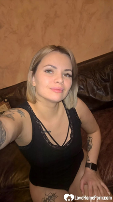 Light-haired honey displays her small bosoms & her sleek-smoothly-shaven cunt in dark-hued lingerie