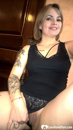 Light-haired honey displays her small bosoms & her sleek-smoothly-shaven cunt in dark-hued lingerie