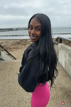 Watch petite Indian babe Fae Love tease and flash her clean-shaven pussy up close on the beach
