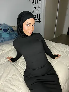Watch her switch between hijab and lingerie while getting off in solo action on the couch