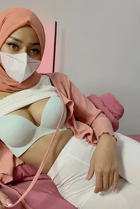 Watch this stunning babe tease her natural tits in a face mask while revealing her rock hard curves