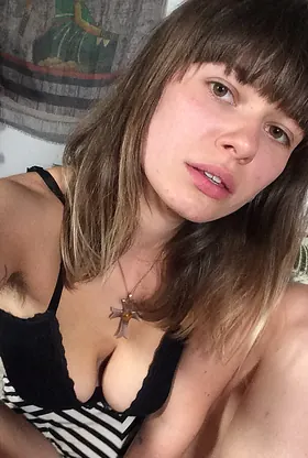 German GF with a stunning smile strips off and flaunts her naked body on the couch