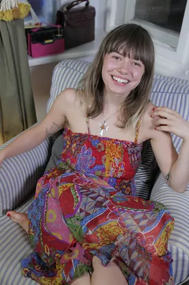 German GF with a stunning smile strips off and flaunts her naked body on the couch