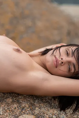 Watch Lilit Ariel's stunning body take off on the beach and reveal her perfect assets