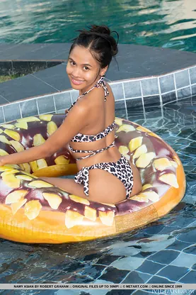 Naughty Thai teen Namy Chinese strips naked and flaunts her tiny tits in the pool