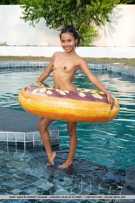 Naughty Thai teen Namy Chinese strips naked and flaunts her tiny tits in the pool