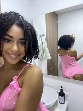 Curly-haired Latina babe Lisandra Official flaunts her swimwear while showing off her big tits and curvy body