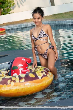 Naughty Thai teen Namy Chinese strips naked and flaunts her tiny tits in the pool