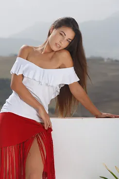 Lorena Garcia flaunts her long dark hair and exposes her clean-shaven legs outdoors